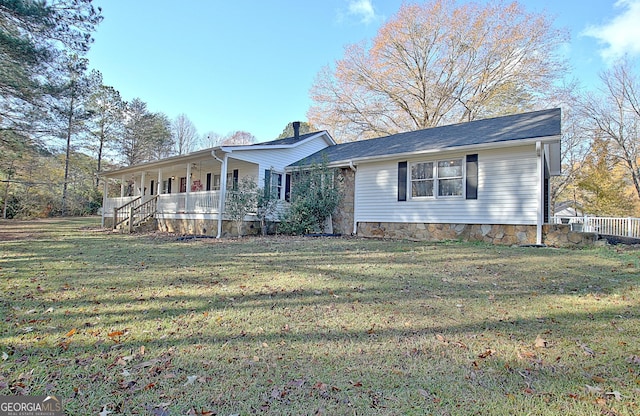 view of front of home with a porch and a front yard