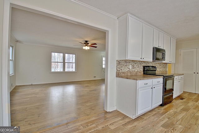 kitchen with black appliances, crown molding, light wood finished floors, ceiling fan, and backsplash