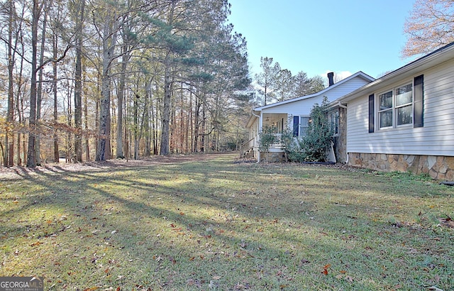 view of grassy yard featuring a porch