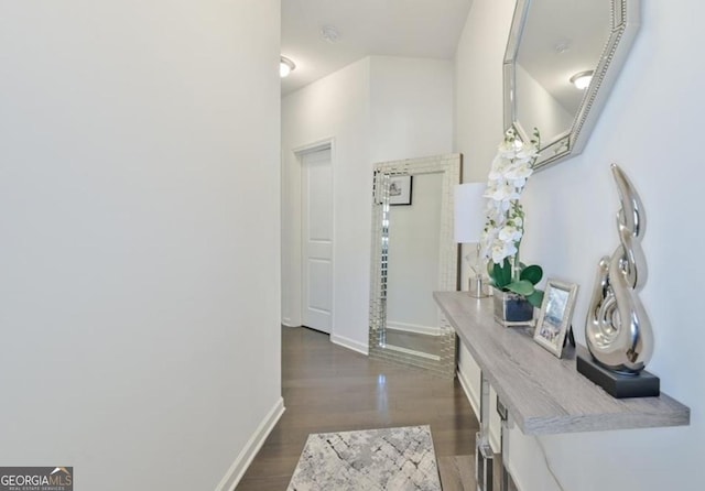 hall with dark wood-style floors and baseboards
