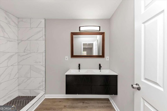 2317 Baywood Dr SE, Atlanta, GA 30315 - full bathroom featuring double vanity, a tile shower, and wood finished floors