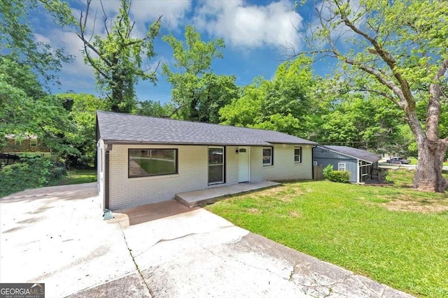 2317 Baywood Dr SE, Atlanta, GA 30315 - ranch-style house featuring brick siding, a front lawn, a porch, and roof with shingles