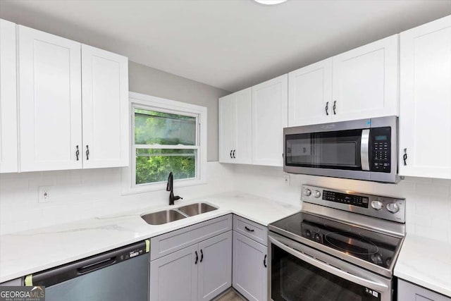 2317 Baywood Dr SE, Atlanta, GA 30315 - kitchen with stainless steel appliances, tasteful backsplash, and white cabinets