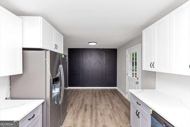 2317 Baywood Dr SE, Atlanta, GA 30315 - kitchen with stainless steel fridge, dishwasher, light wood-style flooring, and white cabinetry