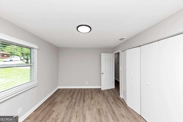 2317 Baywood Dr SE, Atlanta, GA 30315 - unfurnished bedroom featuring light wood-type flooring and a closet