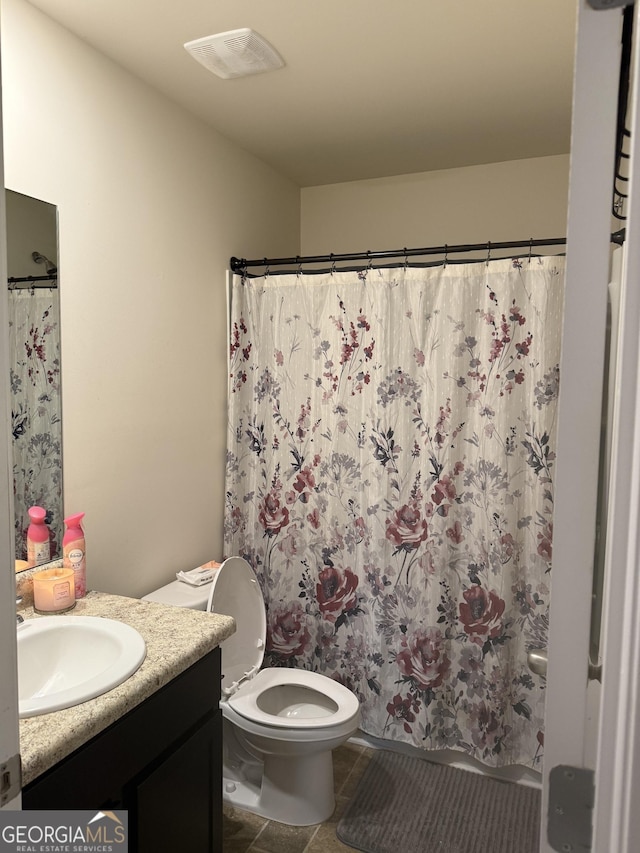 full bathroom with vanity, toilet, and curtained shower