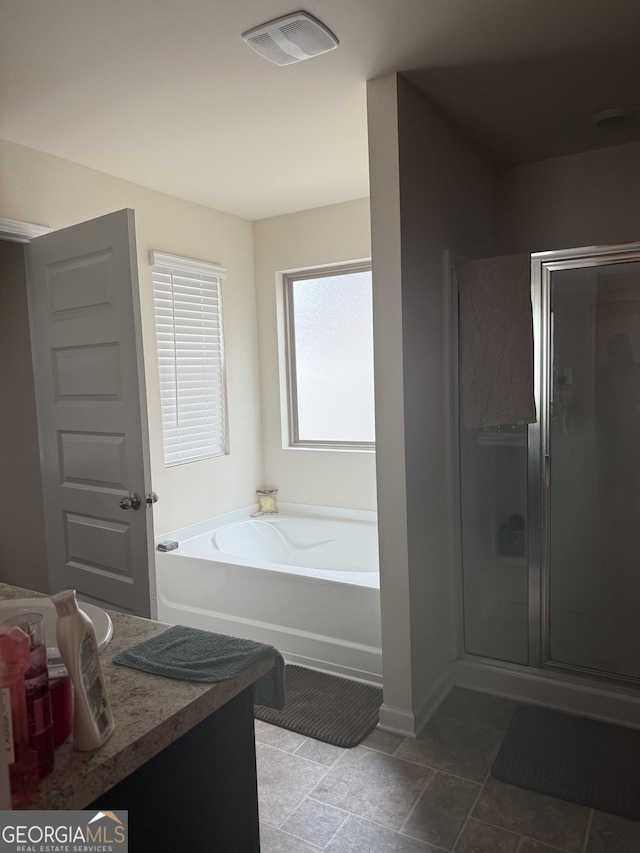 full bath with a stall shower, a bath, baseboards, and vanity