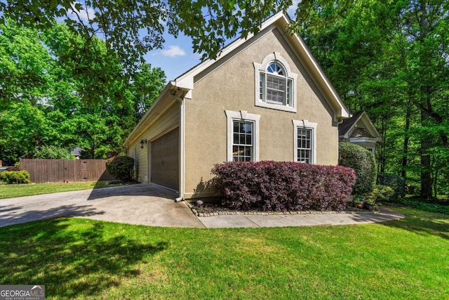 view of front of house with stucco siding, concrete driveway, and an attached garage