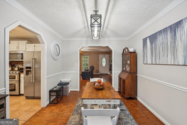 230 Vienna Way, Douglasville, GA 30134 - dining room with a textured ceiling, baseboards, arched walkways, and crown molding