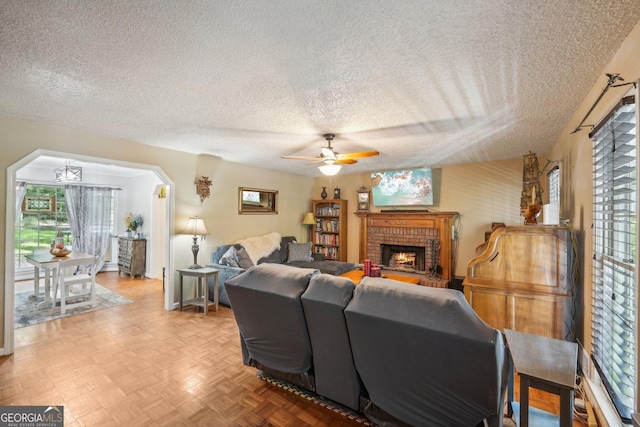 230 Vienna Way, Douglasville, GA 30134 - living room featuring a textured ceiling, ceiling fan, and a fireplace