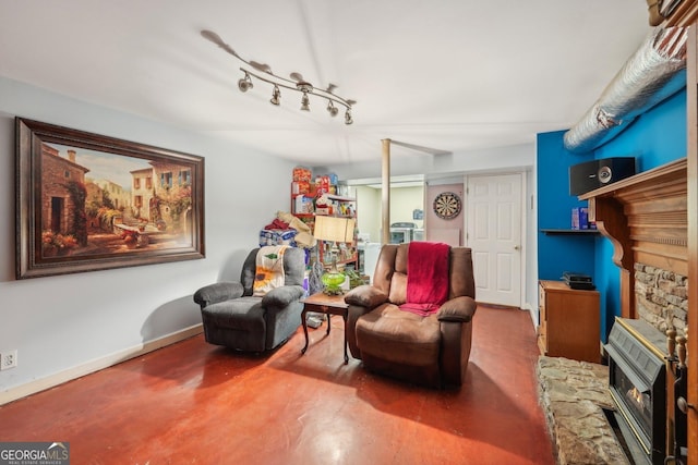 230 Vienna Way, Douglasville, GA 30134 - sitting room with concrete floors, heating unit, a stone fireplace, and baseboards