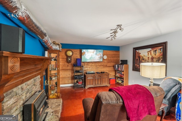 230 Vienna Way, Douglasville, GA 30134 - living area with wood walls, a wood stove, and concrete floors