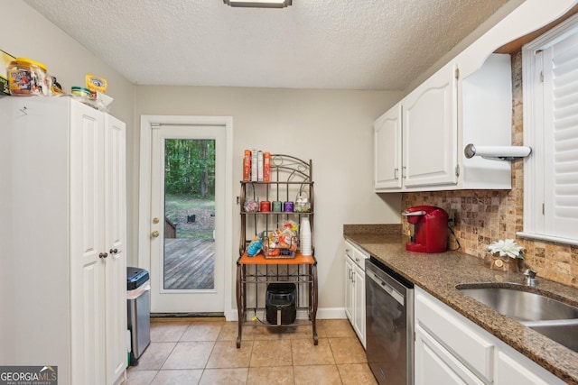 230 Vienna Way, Douglasville, GA 30134 - kitchen with dishwasher, white cabinets, a textured ceiling, backsplash, and light tile patterned floors