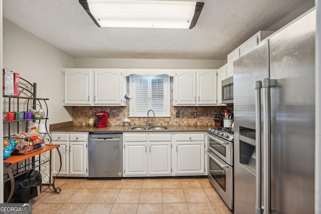 230 Vienna Way, Douglasville, GA 30134 - kitchen featuring stainless steel appliances, a sink, white cabinets, and a textured ceiling
