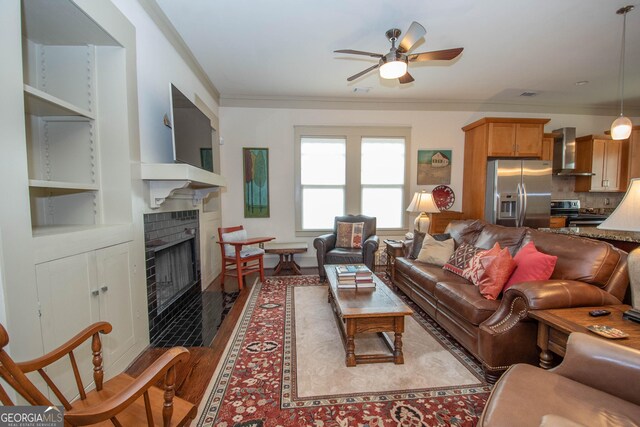 20 Salbide Ave, Newnan, GA 30263 - living room featuring crown molding, ceiling fan, wood finished floors, and a tiled fireplace