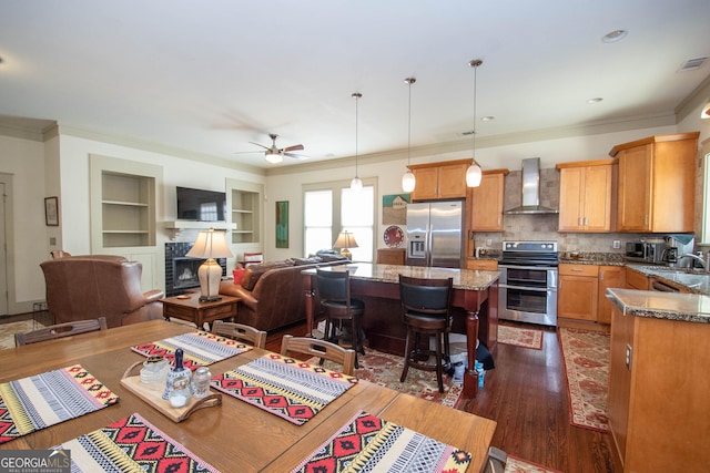 20 Salbide Ave, Newnan, GA 30263 - dining room with ceiling fan, dark wood finished floors, ornamental molding, a fireplace, and built in shelves
