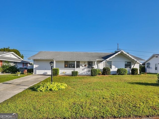 ranch-style home with covered porch, an attached garage, concrete driveway, and a front yard