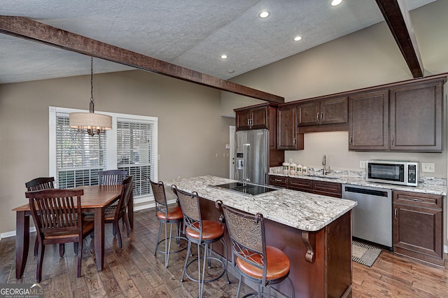 207A Quail Trl, Jackson, GA 30233 - kitchen featuring appliances with stainless steel finishes, a sink, wood finished floors, dark brown cabinets, and a textured ceiling