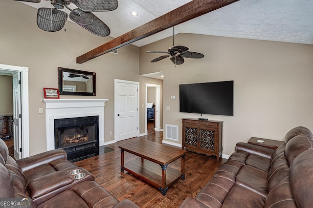 207A Quail Trl, Jackson, GA 30233 - living room featuring a ceiling fan, wood-type flooring, beam ceiling, baseboards, and a fireplace with flush hearth