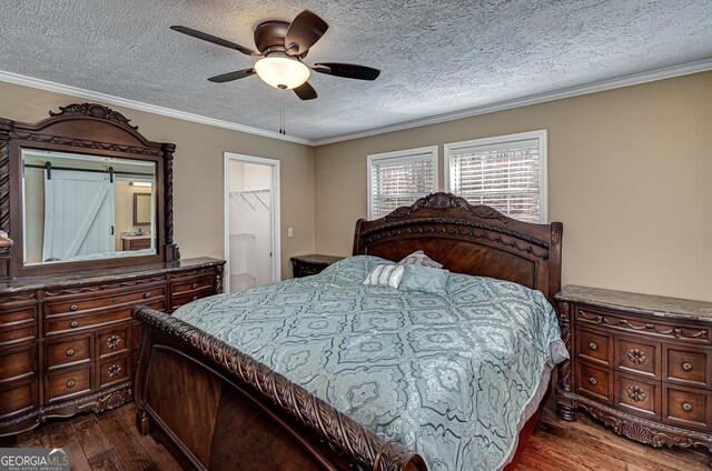 207A Quail Trl, Jackson, GA 30233 - bedroom featuring dark wood-type flooring, a textured ceiling, a ceiling fan, crown molding, and ensuite bathroom
