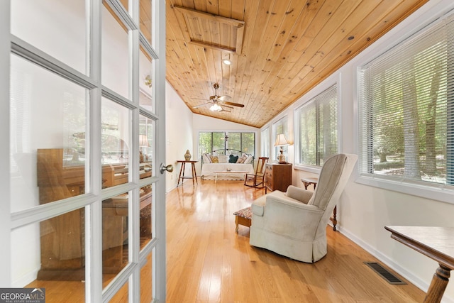 sunroom featuring wood ceiling, vaulted ceiling, wood finished floors, and baseboards