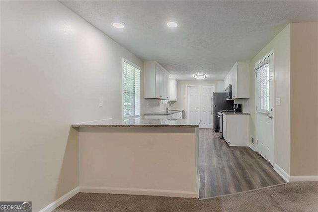 4016 Nations Dr, Douglasville, GA 30135 - kitchen with white cabinets, a textured ceiling, a sink, baseboards, and recessed lighting