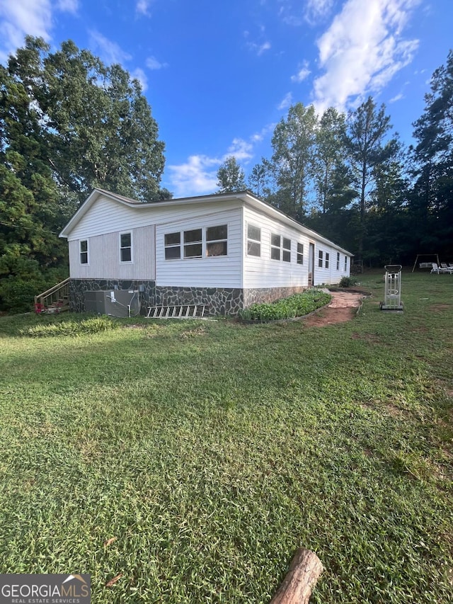 view of side of home featuring a lawn
