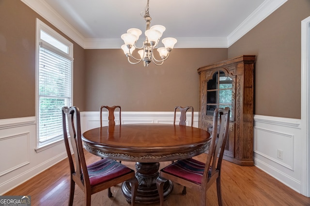 200 Hidden Spring Way, Athens, GA 30605 - dining room featuring a chandelier, wainscoting, light wood finished floors, ornamental molding, and a decorative wall
