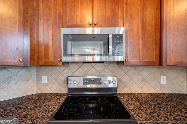 200 Hidden Spring Way, Athens, GA 30605 - kitchen with appliances with stainless steel finishes, brown cabinetry, backsplash, and dark stone counters