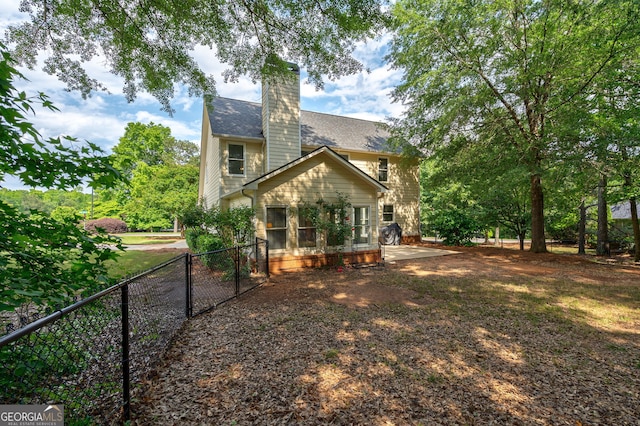 200 Hidden Spring Way, Athens, GA 30605 - rear view of property featuring fence, a chimney, and a shingled roof