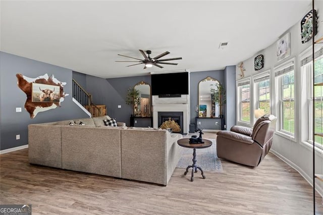 9225 Maple Run Trl, Gainesville, GA 30506 - living room featuring ceiling fan, wood finished floors, stairs, and a fireplace