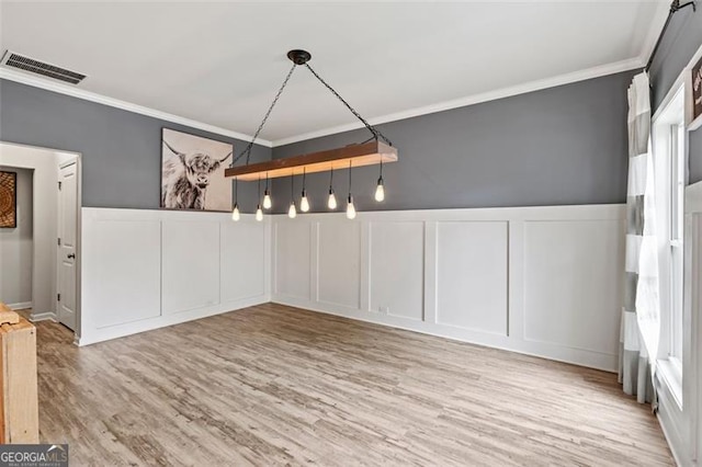 9225 Maple Run Trl, Gainesville, GA 30506 - unfurnished dining area with a decorative wall, crown molding, wood finished floors, and a wainscoted wall