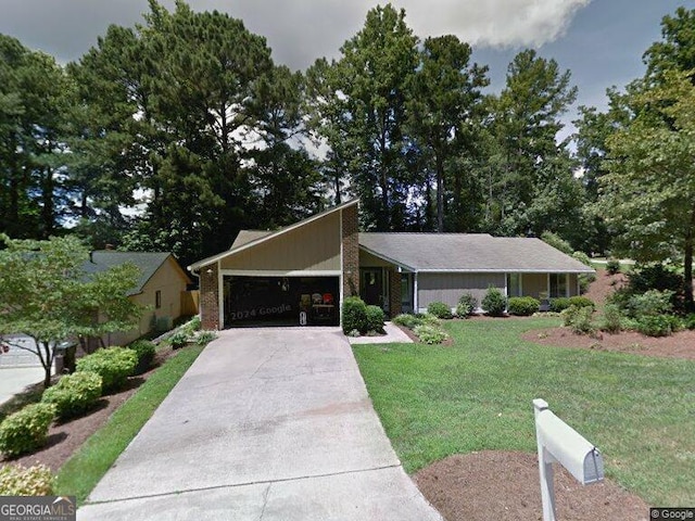 100 Lake Forest Dr, Peachtree City, GA 30269 - mid-century home with a garage, a front lawn, and driveway