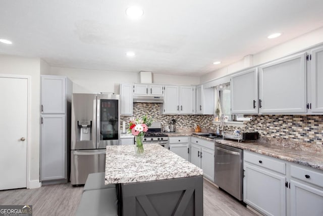 1220 Wade Green Cir NW, Acworth, GA 30102 - kitchen with appliances with stainless steel finishes, under cabinet range hood, a sink, decorative backsplash, and recessed lighting