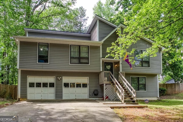 1220 Wade Green Cir NW, Acworth, GA 30102 - split foyer home with an attached garage, fence, and driveway