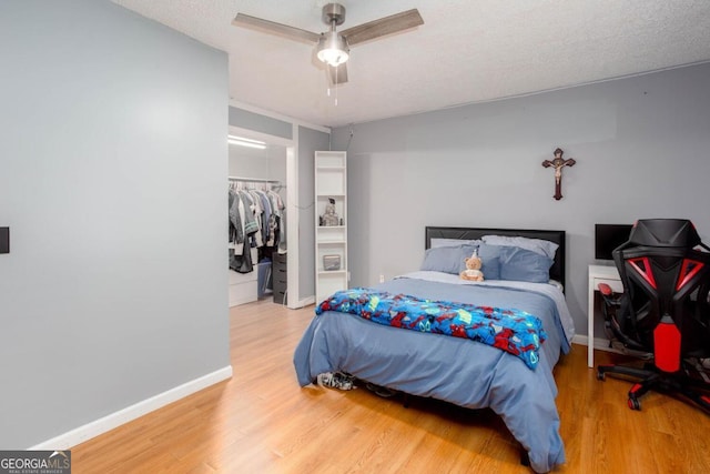 1220 Wade Green Cir NW, Acworth, GA 30102 - bedroom featuring light wood-style floors, baseboards, a closet, and a spacious closet