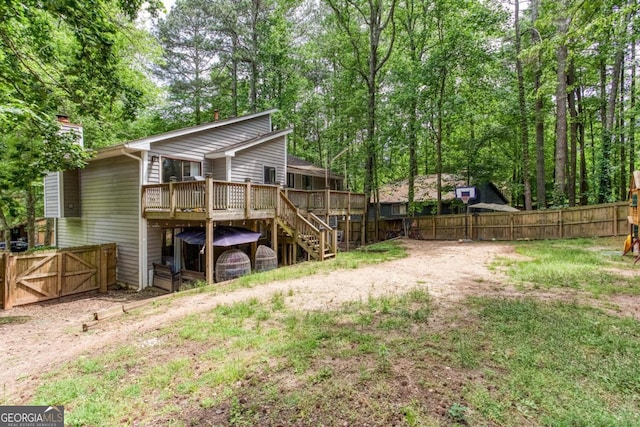 1220 Wade Green Cir NW, Acworth, GA 30102 - back of house featuring a deck, stairway, a fenced backyard, and a gate