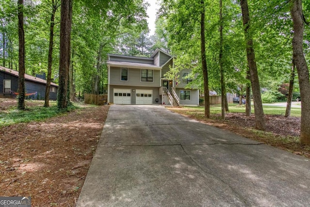 1220 Wade Green Cir NW, Acworth, GA 30102 - view of front of property featuring driveway, a garage, and stairway