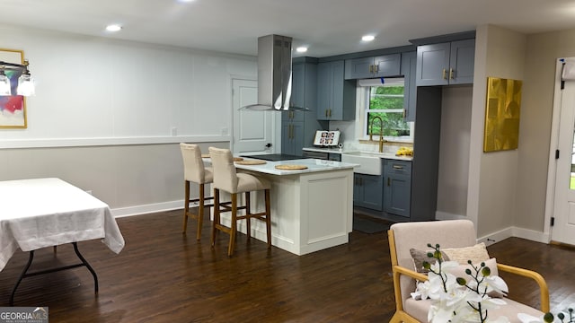 4296 Langdon Dr, Decatur, GA 30035 - kitchen featuring a sink, exhaust hood, light countertops, dark wood-style flooring, and a kitchen breakfast bar