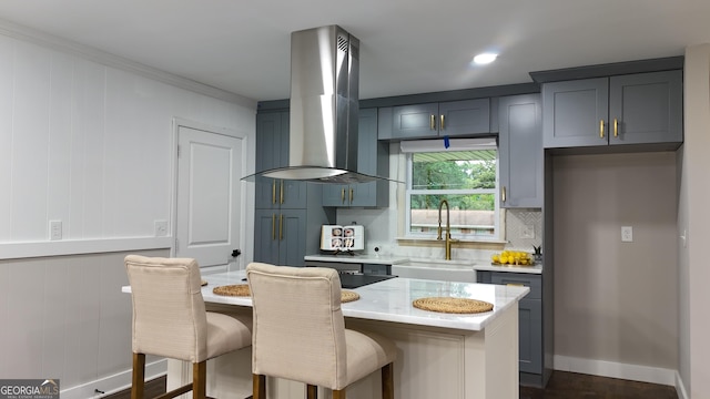 4296 Langdon Dr, Decatur, GA 30035 - kitchen featuring island range hood, a sink, decorative backsplash, a breakfast bar, and crown molding