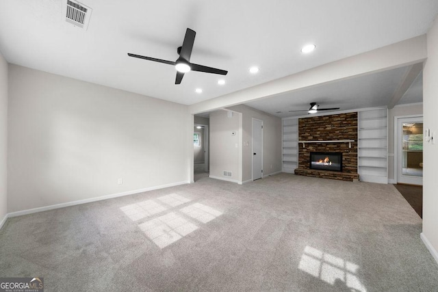 unfurnished living room with a ceiling fan, baseboards, carpet floors, recessed lighting, and a fireplace