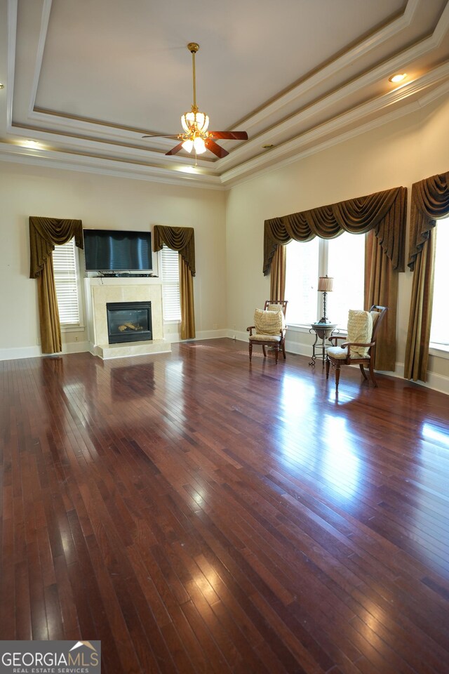 1010 Forest Overlook Dr SW, Atlanta, GA 30331 - unfurnished living room with a tray ceiling, plenty of natural light, a ceiling fan, crown molding, and hardwood / wood-style flooring