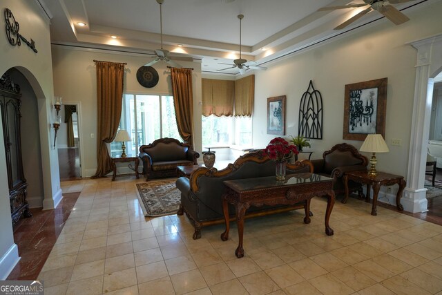 1010 Forest Overlook Dr SW, Atlanta, GA 30331 - living room featuring ceiling fan, a raised ceiling, arched walkways, and decorative columns