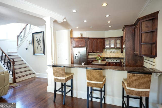 1010 Forest Overlook Dr SW, Atlanta, GA 30331 - kitchen with stainless steel fridge, a peninsula, recessed lighting, backsplash, and ornamental molding