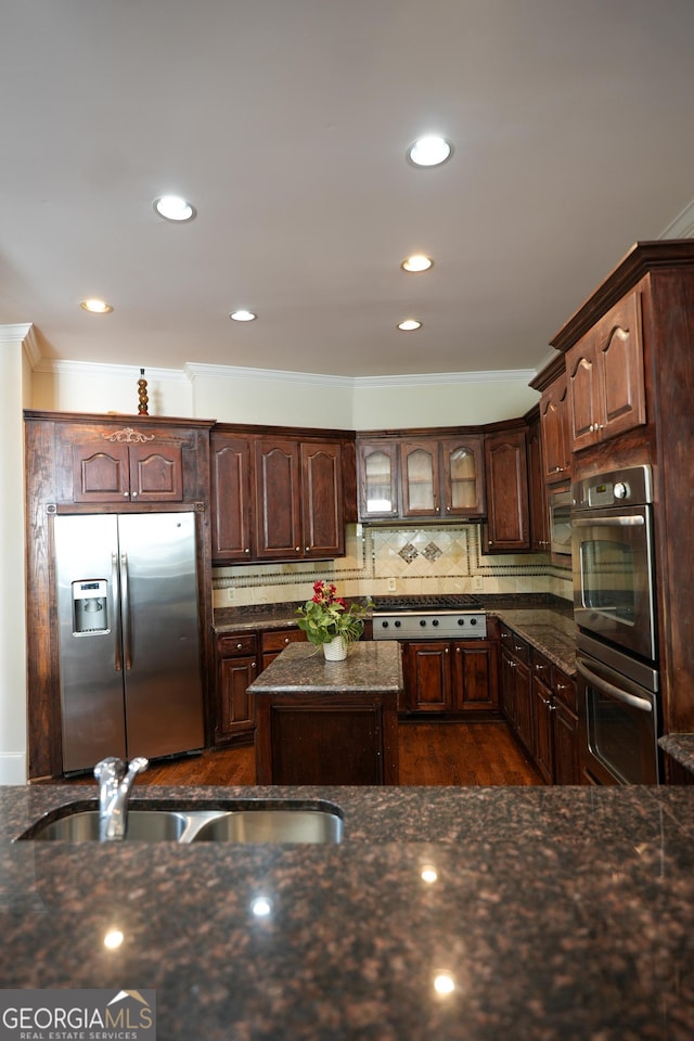 1010 Forest Overlook Dr SW, Atlanta, GA 30331 - kitchen with stainless steel appliances, a sink, ornamental molding, dark stone countertops, and tasteful backsplash