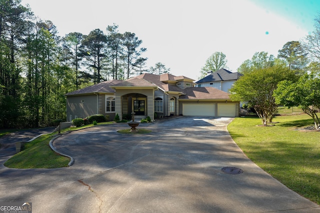 1010 Forest Overlook Dr SW, Atlanta, GA 30331 - view of front of home featuring curved driveway, a front yard, and an attached garage