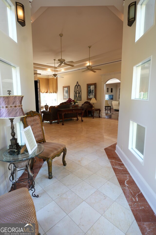 1010 Forest Overlook Dr SW, Atlanta, GA 30331 - living room with arched walkways, a towering ceiling, a ceiling fan, and baseboards