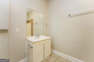 bathroom featuring vanity, baseboards, and tile patterned floors