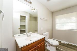 bathroom with vanity, toilet, and wood finished floors