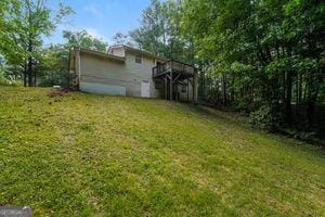 view of grassy yard with a wooden deck
